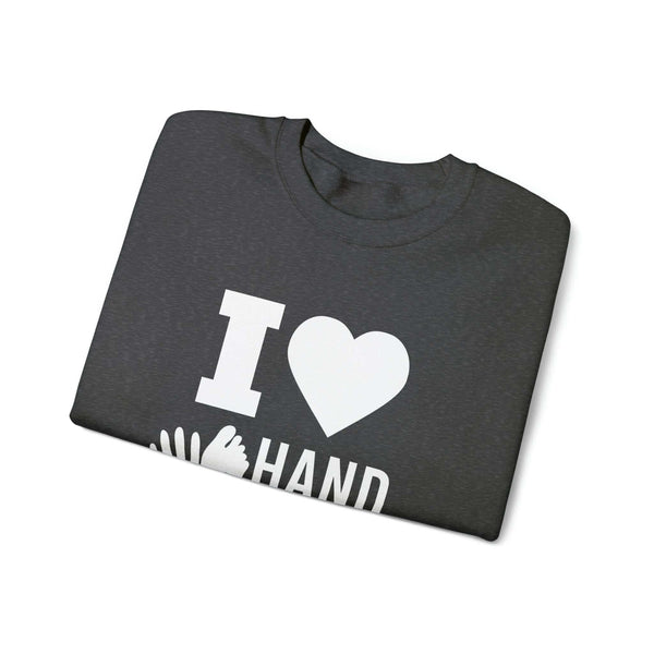 "I Love Hand & Foot" Unisex Heavy Blend Crewneck Sweatshirt folded, featuring a cozy design for comfort and sustainability.