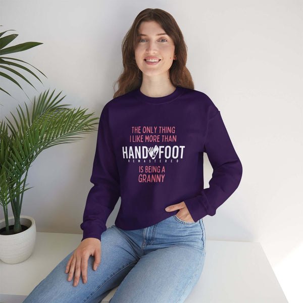Woman wearing a 'Being a Granny' unisex heavy blend crewneck sweatshirt, showcasing cozy comfort and sustainability. Perfect gift for grandmothers.