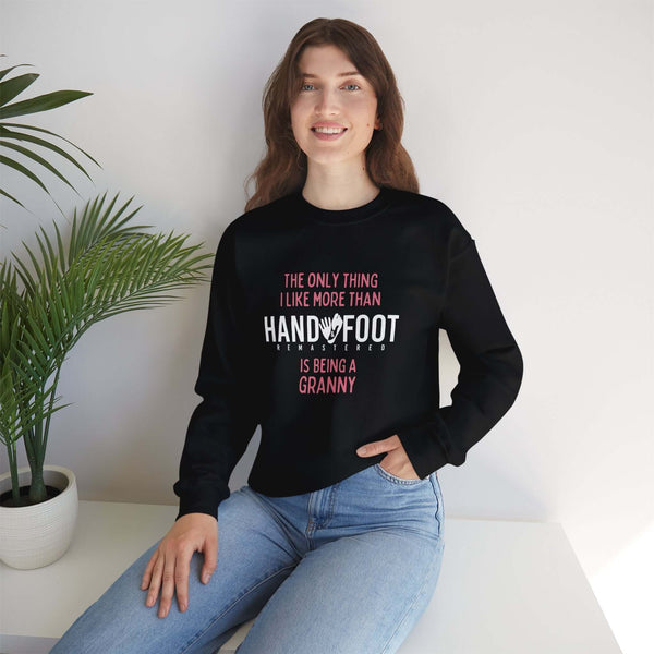 Woman wearing a 'Being a Granny' unisex heavy blend crewneck sweatshirt, ideal gift for grandmothers, seated next to indoor plants.