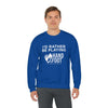 Man wearing a blue "I'd Rather Be Playing Hand & Foot" crewneck sweatshirt, showcasing casual and cozy style.
