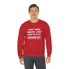 Man wearing Therapy Unisex Heavy Blend Crewneck Sweatshirt in red, featuring the Hand & Foot Remastered game slogan.