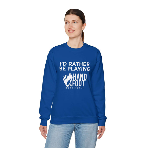 Person wearing a blue crewneck sweatshirt with 'I'd Rather Be Playing Hand & Foot Remastered' text, showcasing cozy warmth and style.