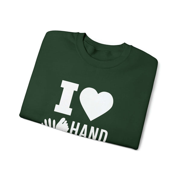 Folded green I Love Hand & Foot unisex crewneck sweatshirt with a heart graphic on front, showcasing cozy and sustainable design.
