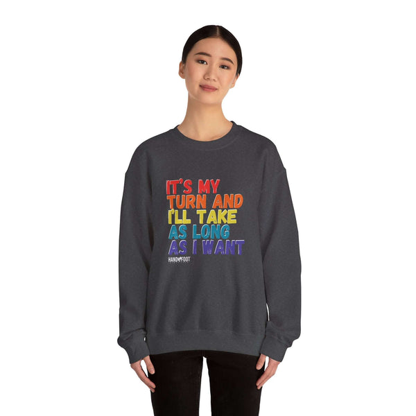 Person wearing 'It's My Turn' unisex crewneck sweatshirt, showcasing colorful text about taking time, perfect for board game enthusiasts.