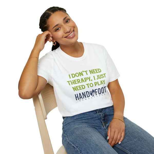 Woman wearing Therapy Softstyle T-Shirt with "I Don't Need Therapy, I Just Need to Play Hand & Foot" text, sitting and smiling.