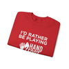 Red crewneck sweatshirt with 'I'd Rather Be Playing Hand Foot' text, folded neatly, showcasing casual style and comfort.