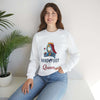 Model wearing white Hand & Foot Queen Unisex Heavy Blend Crewneck Sweatshirt, sitting in a bright room with a plant.