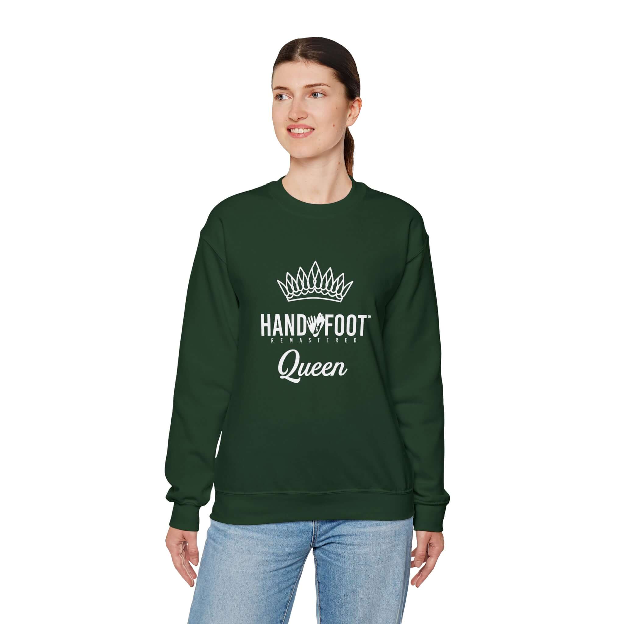 Model wearing green Hand & Foot Queen Unisex Heavy Blend Crewneck Sweatshirt with crown logo, showcasing comfort and style.
