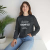 Woman wearing a 'Being a Grandmom' unisex crewneck sweatshirt, sitting casually beside a potted plant, smiling at the camera.
