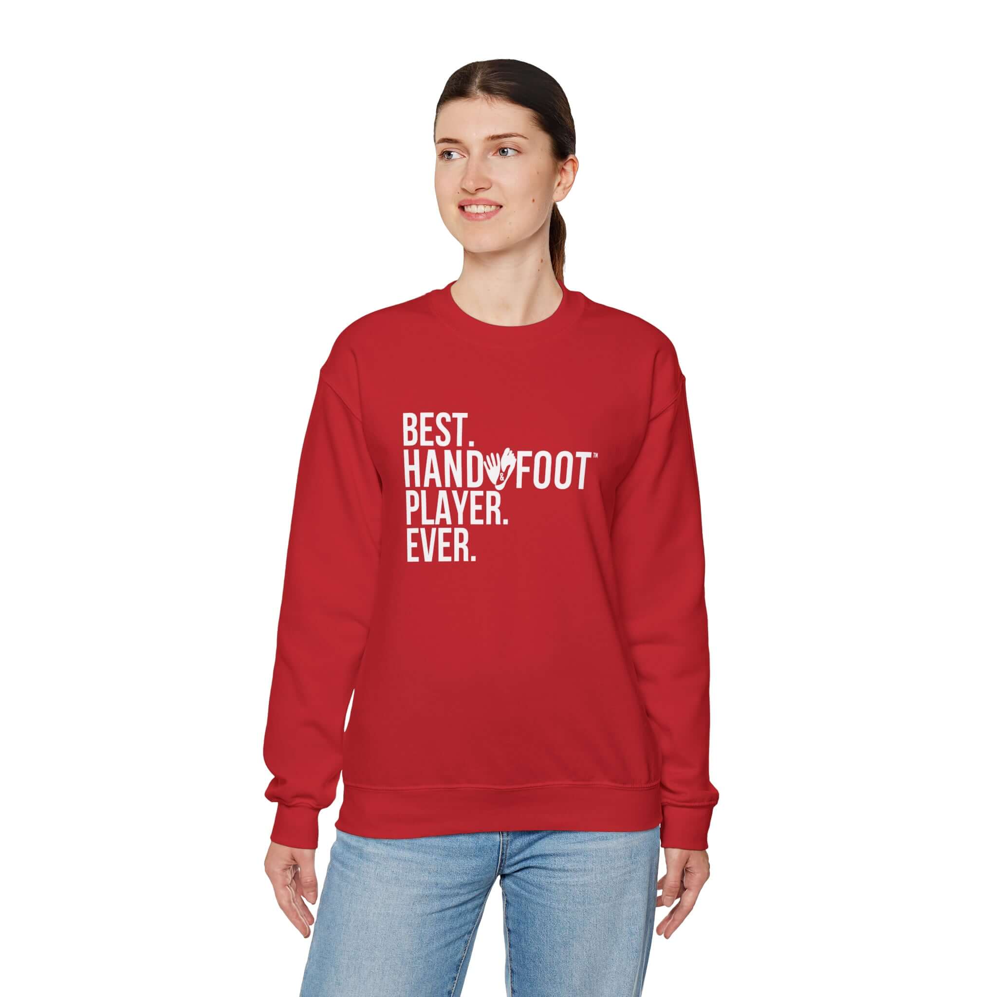 Woman wearing red 'Best Hand Foot Player Ever' unisex heavy blend crewneck sweatshirt, emphasizing comfort and sustainable fashion.