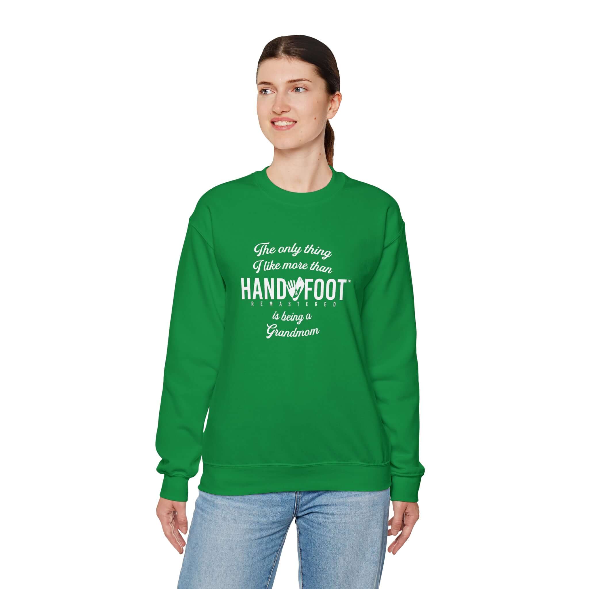 Model wearing green 'Being a Grandmom' crewneck sweatshirt with hand and foot design.