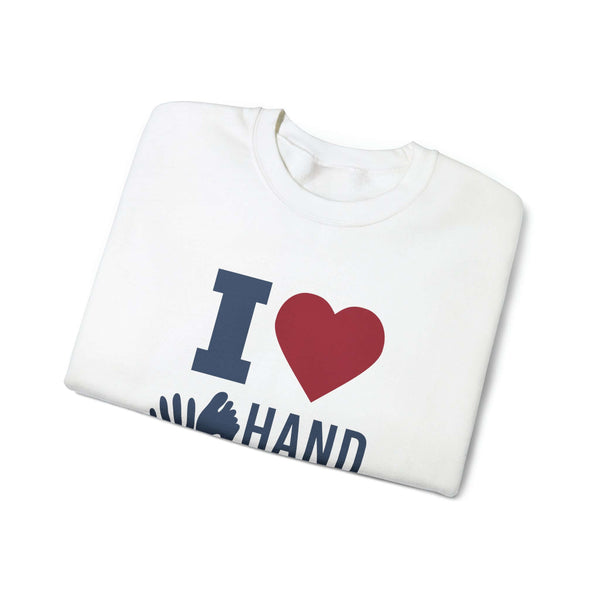 Folded white crewneck sweatshirt with "I Love Hand & Foot" text and heart graphic.