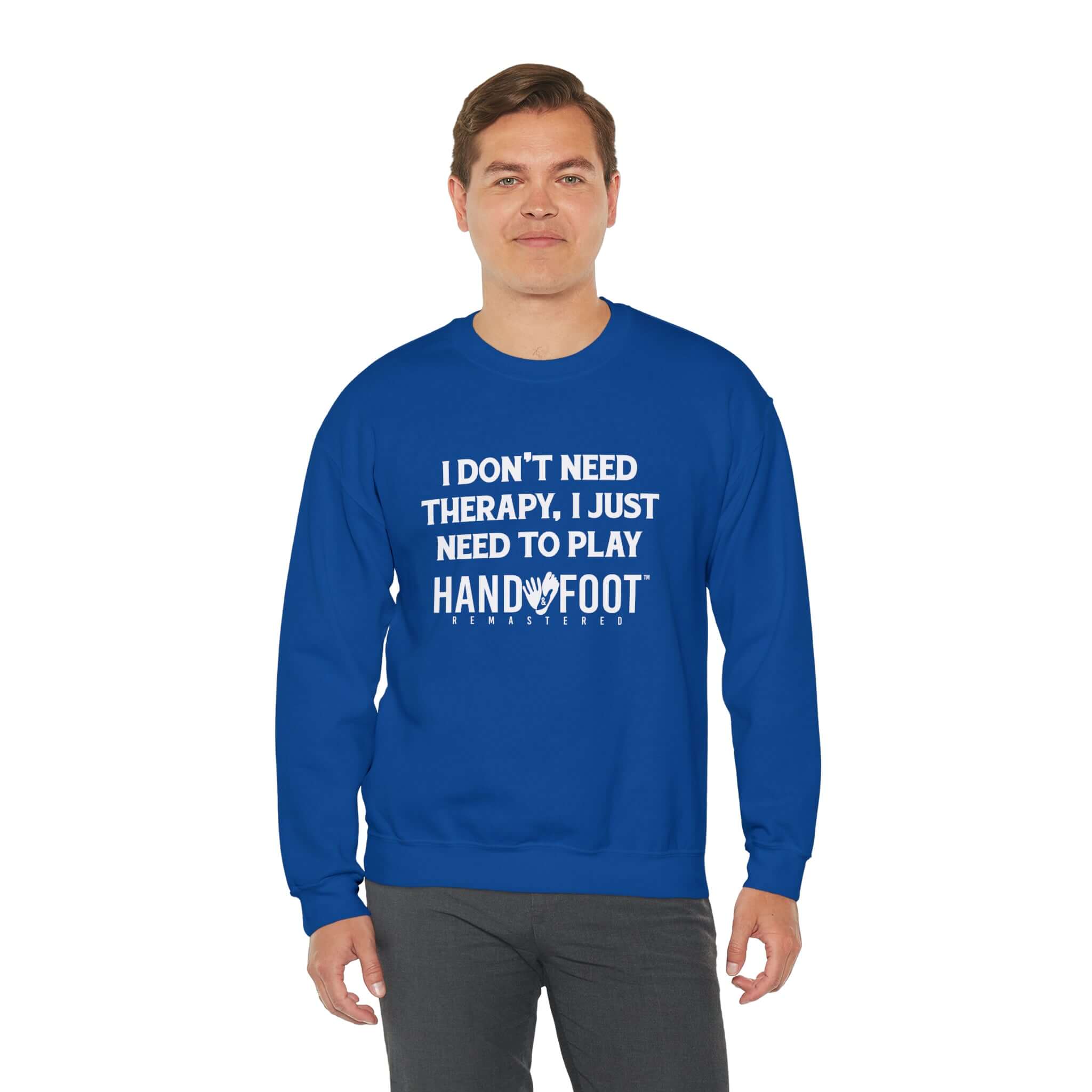 Man wearing a blue Therapy Unisex Heavy Blend Crewneck Sweatshirt with Hand & Foot Remastered text.