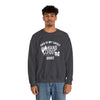 Model wearing dark gray Lucky Unisex Heavy Blend Crewneck Sweatshirt with printed design, showcasing comfort and style.