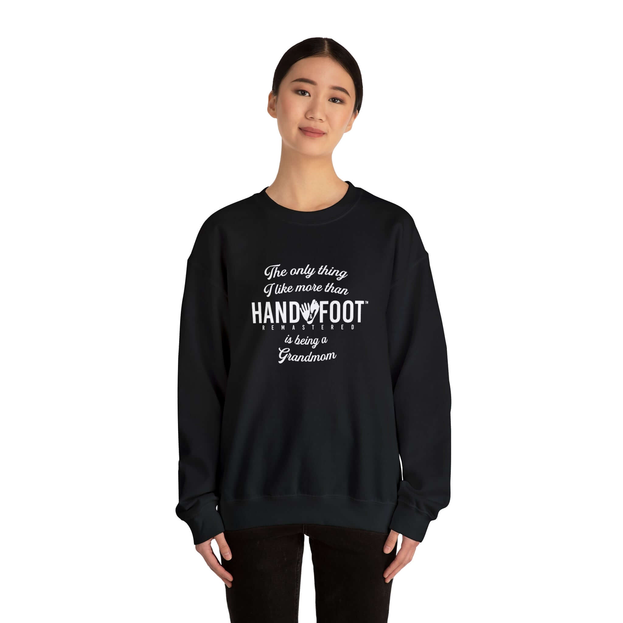 Woman wearing 'Being a Grandmom' unisex crewneck sweatshirt, black, with white lettering, for cozy comfort and sustainable fashion.