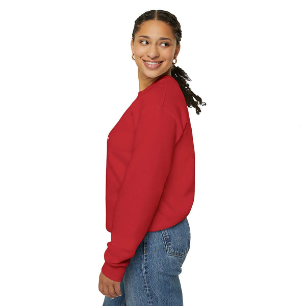 Woman wearing a red 'Being a Grandmom' unisex heavy blend crewneck sweatshirt, showcasing comfort and style.