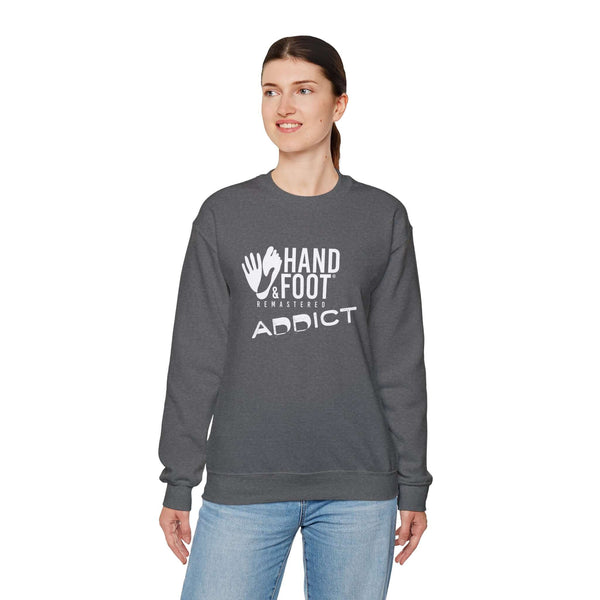 Model wearing a Hand & Foot Addict unisex heavy blend crewneck sweatshirt in dark grey, showcasing comfort and style.