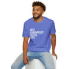 Man wearing Best Player Ever Softstyle T-Shirt in blue with white text, sitting against a white backdrop.