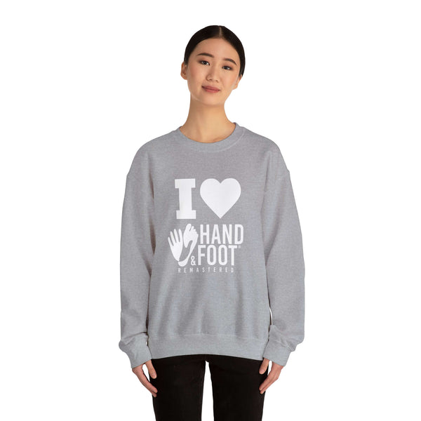 I Love Hand & Foot unisex heavy blend crewneck sweatshirt worn by a person, featuring cozy and sustainable fashion.