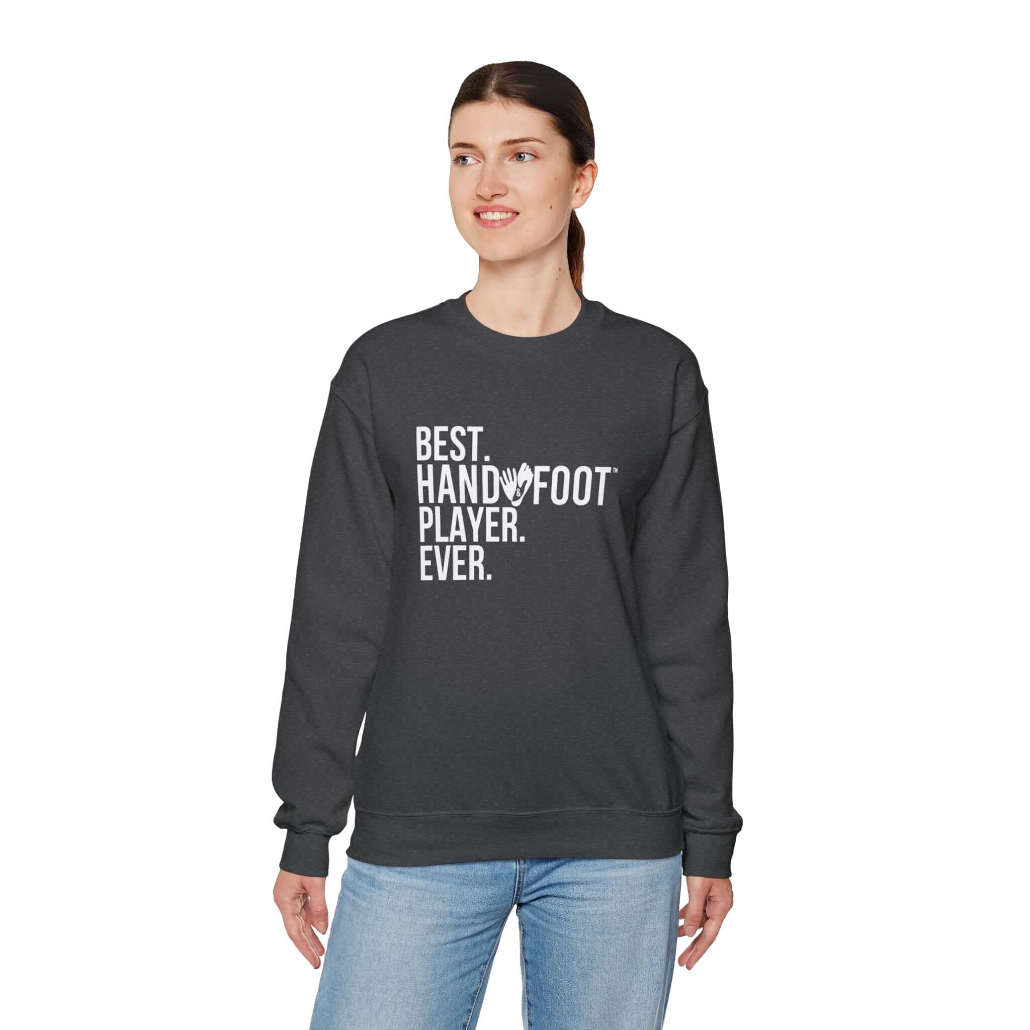 Woman wearing Best Player Ever unisex heavy blend crewneck sweatshirt with hand and foot player design in dark color.