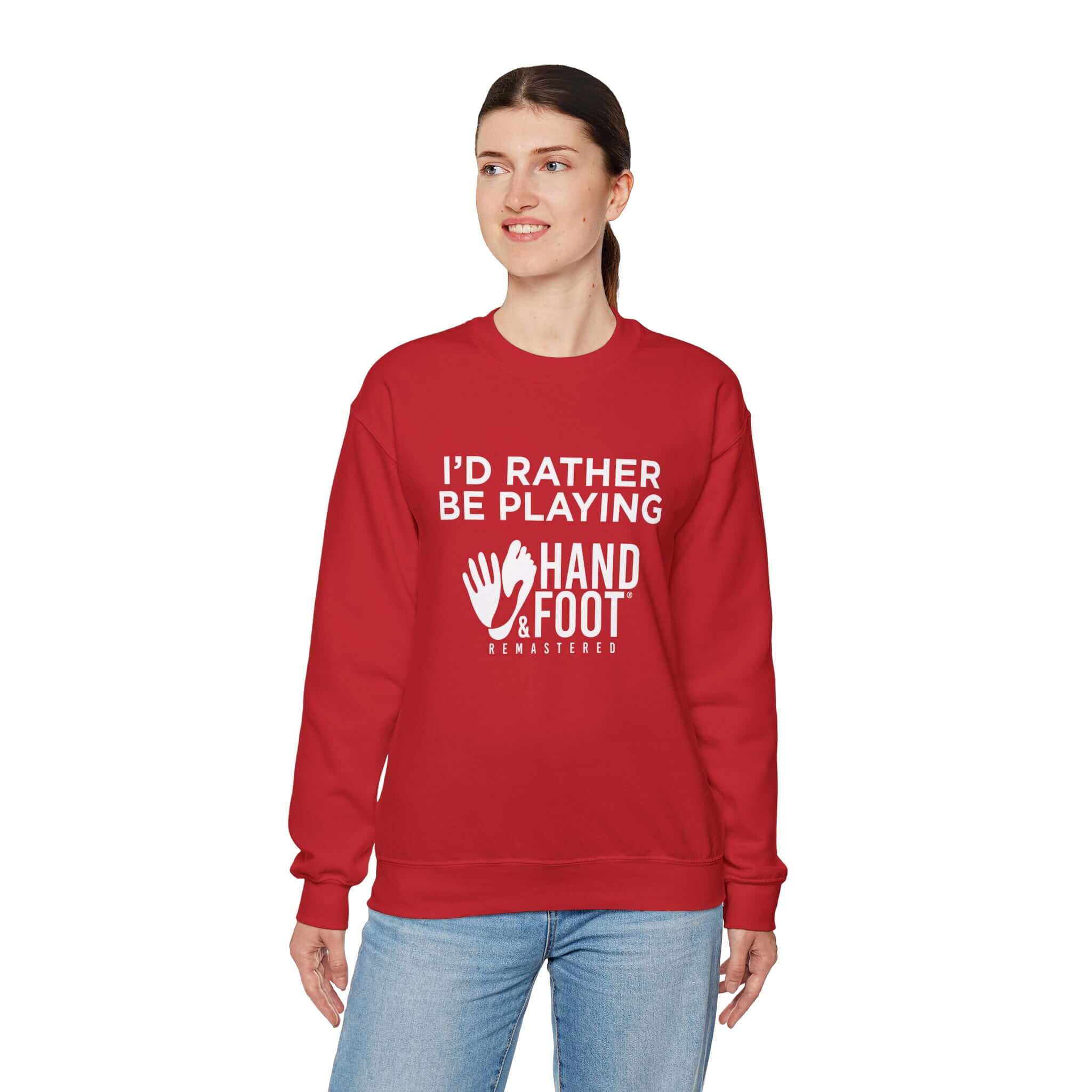 Model wearing red unisex crewneck sweatshirt with 'I'd Rather Be Playing' slogan and Hand & Foot graphics.