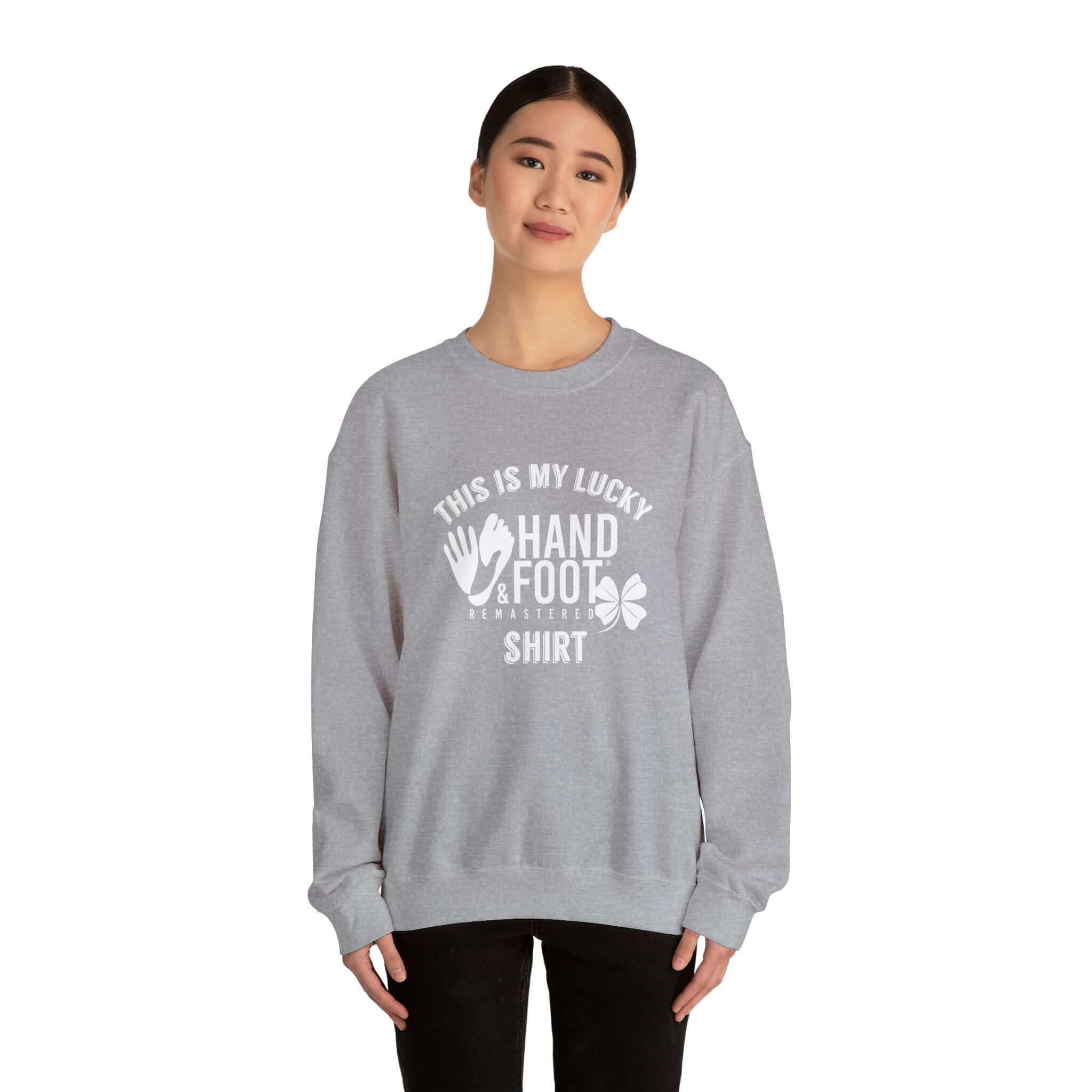 Model wearing gray Lucky Unisex Heavy Blend Crewneck Sweatshirt with 'This is my lucky hand & foot shirt' graphic.
