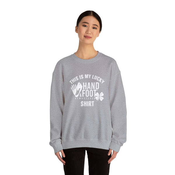 Model wearing gray Lucky Unisex Heavy Blend Crewneck Sweatshirt with 'This is my lucky hand & foot shirt' graphic.