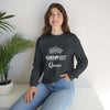 Woman wearing Hand & Foot Queen Unisex Heavy Blend Crewneck Sweatshirt, black, cozy and sustainable fashion, seated indoors next to a plant.