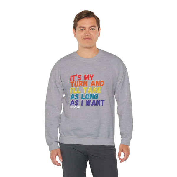 Model wearing "It's My Turn" unisex crewneck sweatshirt, heavy blend, with colorful text.
