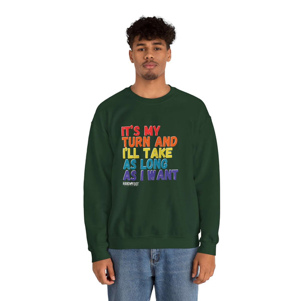 Model wearing a green unisex crewneck sweatshirt with the text "It's My Turn and I'll Take As Long As I Want" in colorful letters.