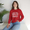 Woman wearing a red crewneck sweatshirt with 'I Don't Need Therapy, I Just Need to Play Hand and Foot' text, sitting casually.