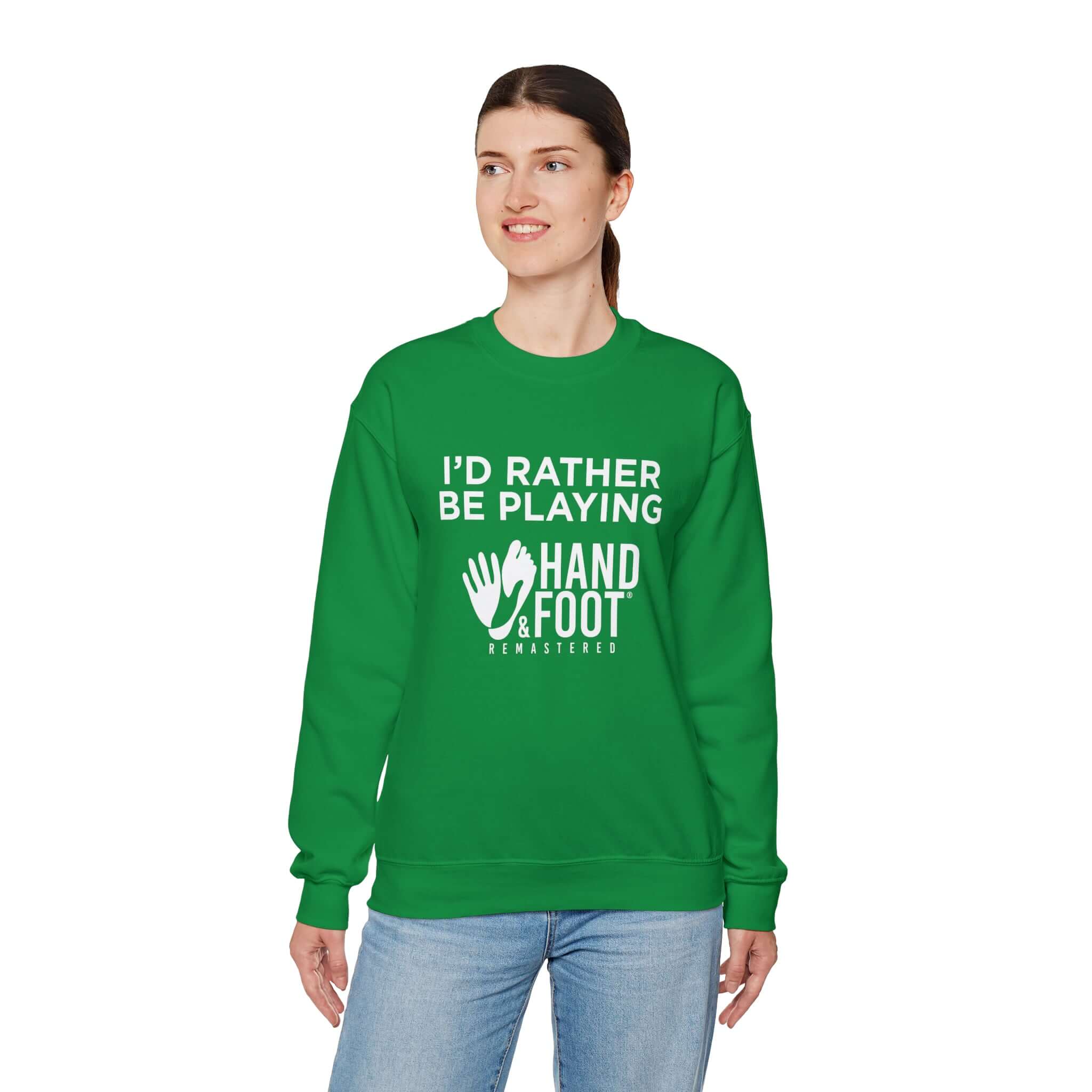 Unisex green crewneck sweatshirt with 'I'd Rather Be Playing Hand and Foot Remastered' text, worn by a woman.
