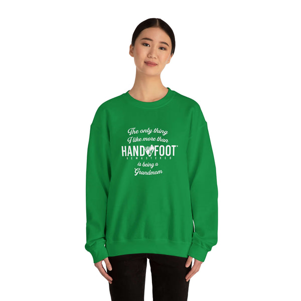 Person wearing green "Being a Grandmom" unisex heavy blend crewneck sweatshirt, perfect cozy gift for grandmothers.