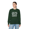 Woman wearing green Therapy Unisex Heavy Blend Crewneck Sweatshirt with text about playing Hand & Foot Remastered.