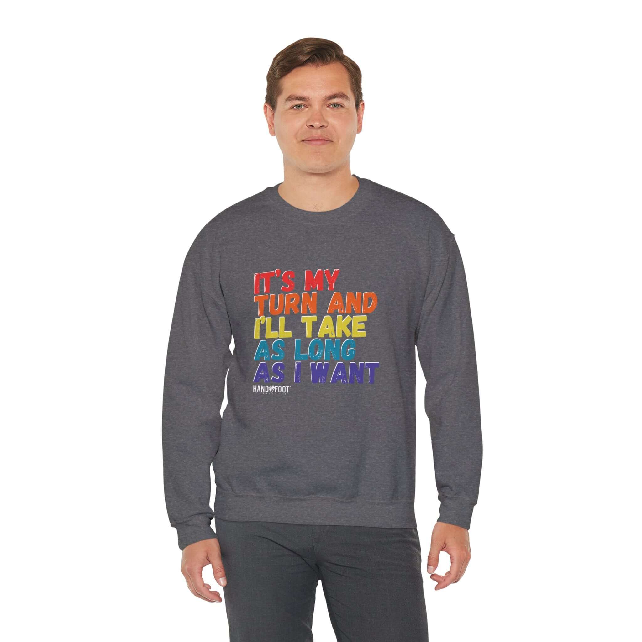 Model wearing 'It's My Turn' unisex crewneck sweatshirt, gray with colorful text