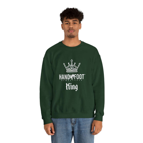 Model wearing Hand & Foot King Unisex Heavy Blend Crewneck Sweatshirt in dark green with crown graphic, offering comfort and style.