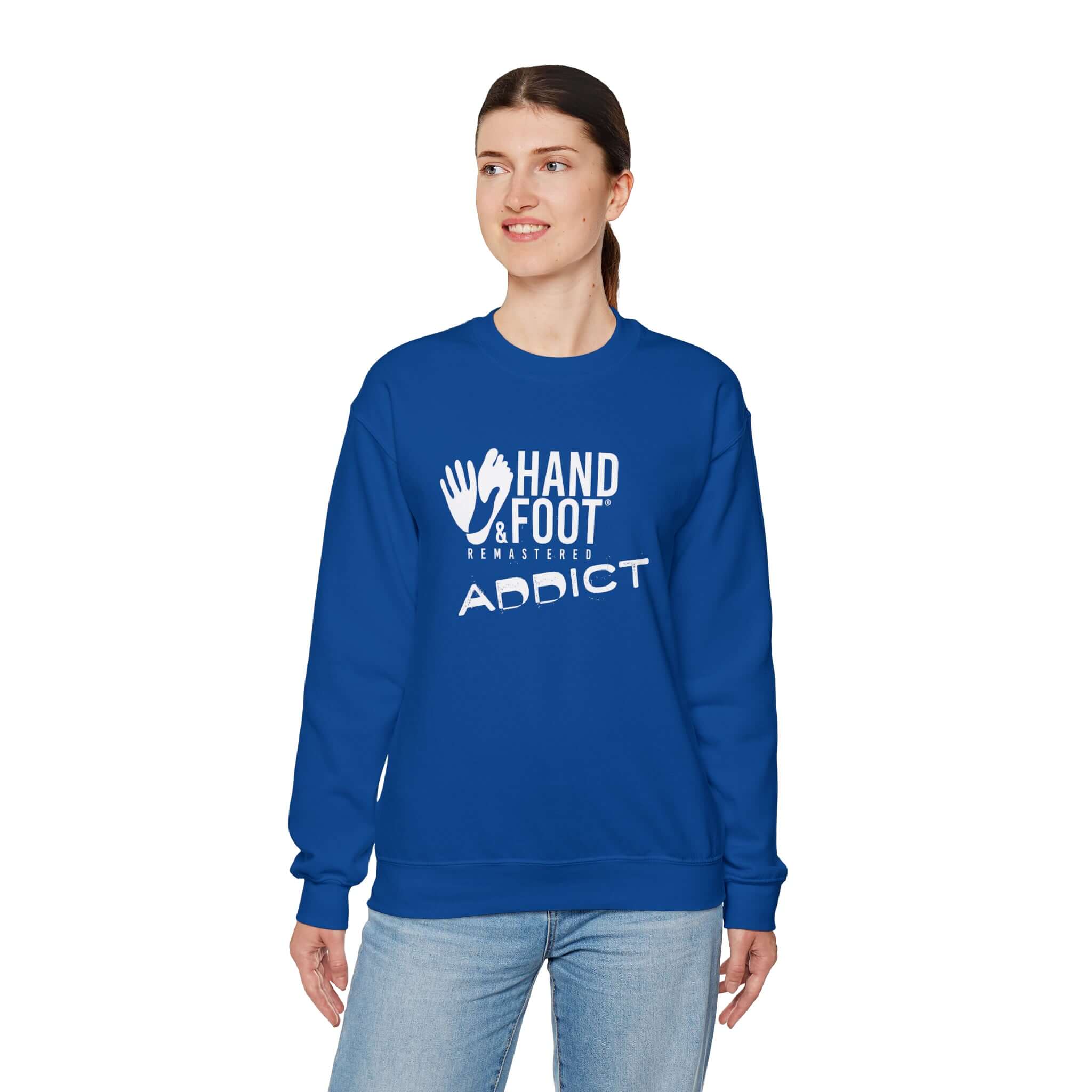 Unisex crewneck sweatshirt in blue, featuring 'Hand & Foot Addict' graphic, worn by model standing.