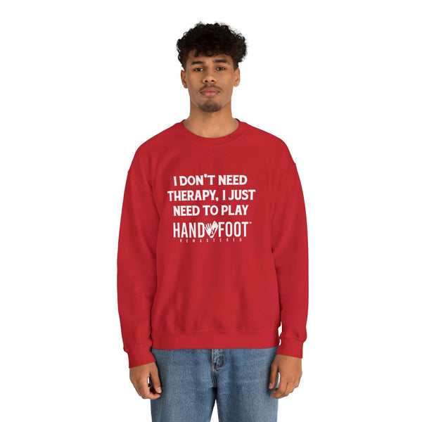 Person wearing a red Therapy Unisex Heavy Blend Crewneck Sweatshirt with Hand & Foot Remastered text, showcasing cozy, sustainable fashion.