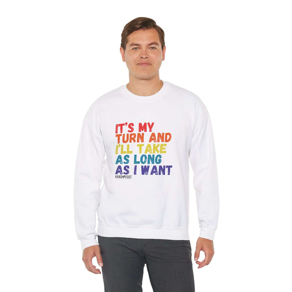 Model wearing 'It's My Turn' unisex white crewneck sweatshirt with colorful print, promoting patience and individuality.