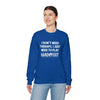 Woman wearing blue Therapy Unisex Crewneck Sweatshirt with Hand & Foot Remastered text, promoting comfort and sustainability.