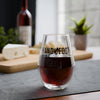Hand & Foot Stemless Wine Glass - Black with red wine, placed on table, cheese and wine bottle in background.