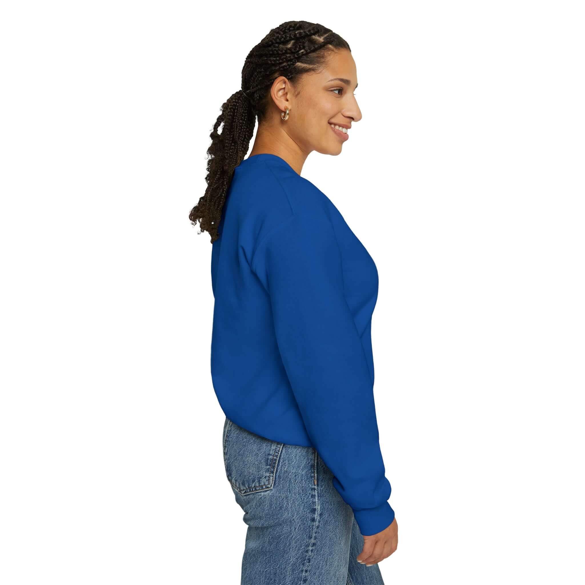 Side view of a person wearing a blue unisex heavy blend crewneck sweatshirt, showcasing cozy casual style.