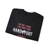 Folded black unisex crewneck sweatshirt with "The Only Thing I Like More Than Handy Foot Remastered Is Being A" printed in white and pink letters.