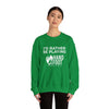 Model wearing green "I'd Rather Be Playing" heavy blend crewneck sweatshirt for cozy comfort and conscious fashion.