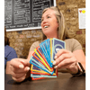 Woman smiling and holding colorful game cards while playing Scratch & Dent Hand & Foot Remastered.