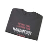 Folded black sweatshirt with text "The only thing I like more than Handy Foot Remastered is" emphasizing casual style.