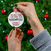 Woman holding "Being a Grandpa" ceramic ornament near Christmas tree, perfect holiday gift for grandpas.