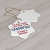 Star-shaped ceramic ornament with the text: 'The only thing I like more than hand & foot is being a grandpa.' Two ornaments displayed on wood surface.