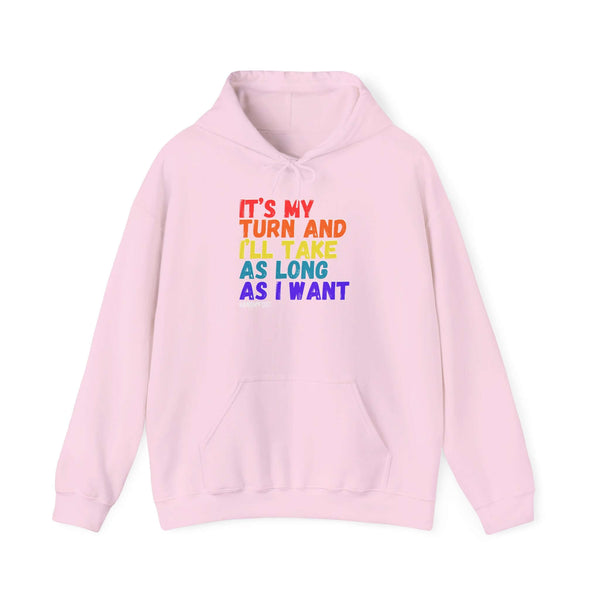 Pink hooded sweatshirt with colorful text 'It's My Turn and I'll Take As Long As I Want', featuring a cozy kangaroo pouch pocket.