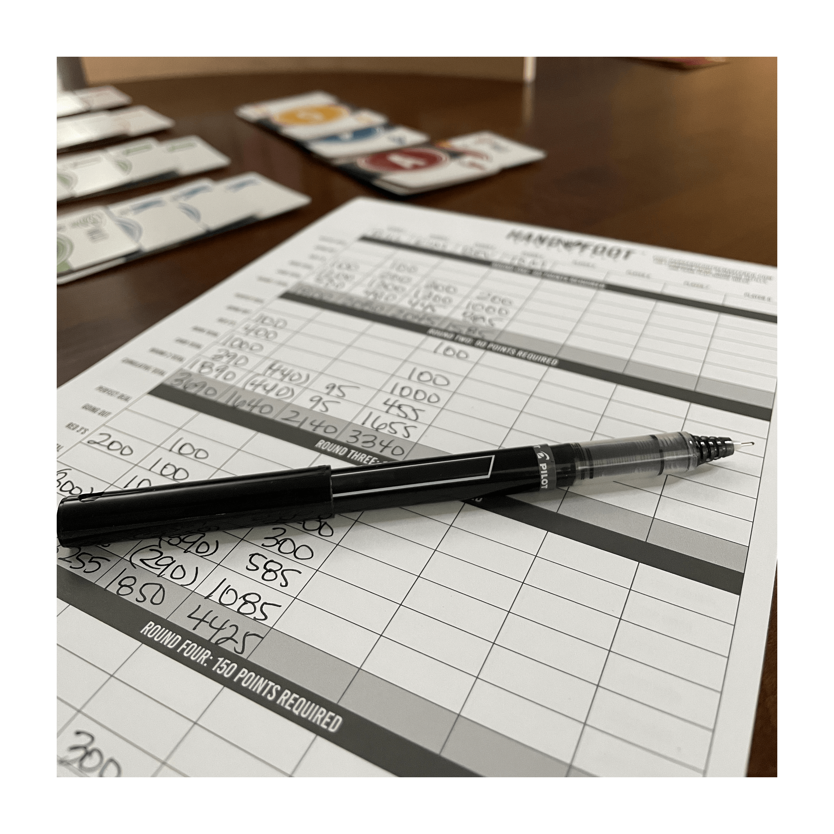 Score pad and pen for Hand & Foot Remastered Game Sets, showing points tally and game instructions.